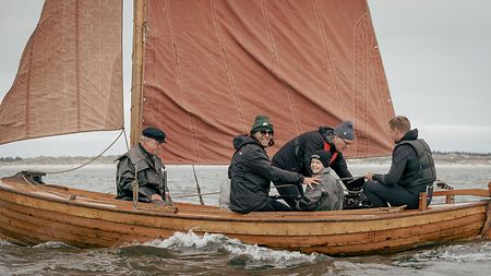 In challenging scenes, such as shooting on a sailboat in a storm, DP Karl says he operated the camera in his lap, adapting in real time to the environment and the actors while relying on his focus puller to not miss a moment.