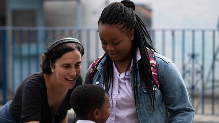 Director Sarah Gavron and two young actresses on the set of “Rocks”