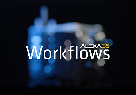 A white typeface saying "ALEXA35 Workflows" on top of an unsharp image of ALEXA 35 in front of a black background.
