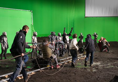 A film set with around 12 people, 4 of those are crew. ALEXA Plus on a dolly in front of a greenscreen.
