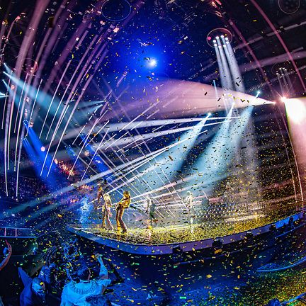 A vibrant Eurovision performance with confetti and a live band using Claypaky equipment for capturing the show